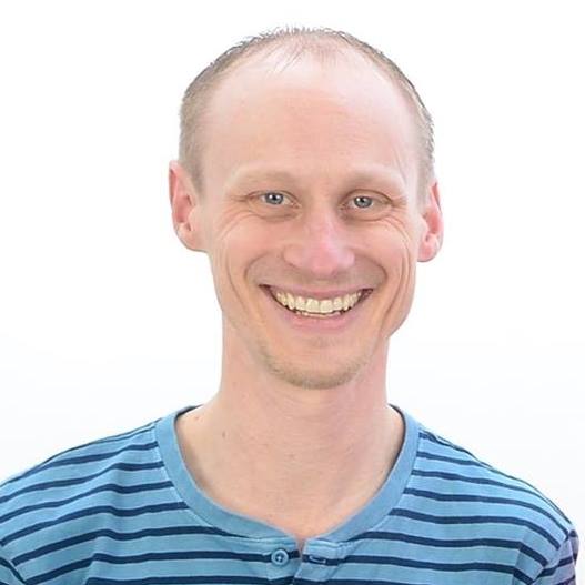 Man in a blue stripped t-shirt smiling