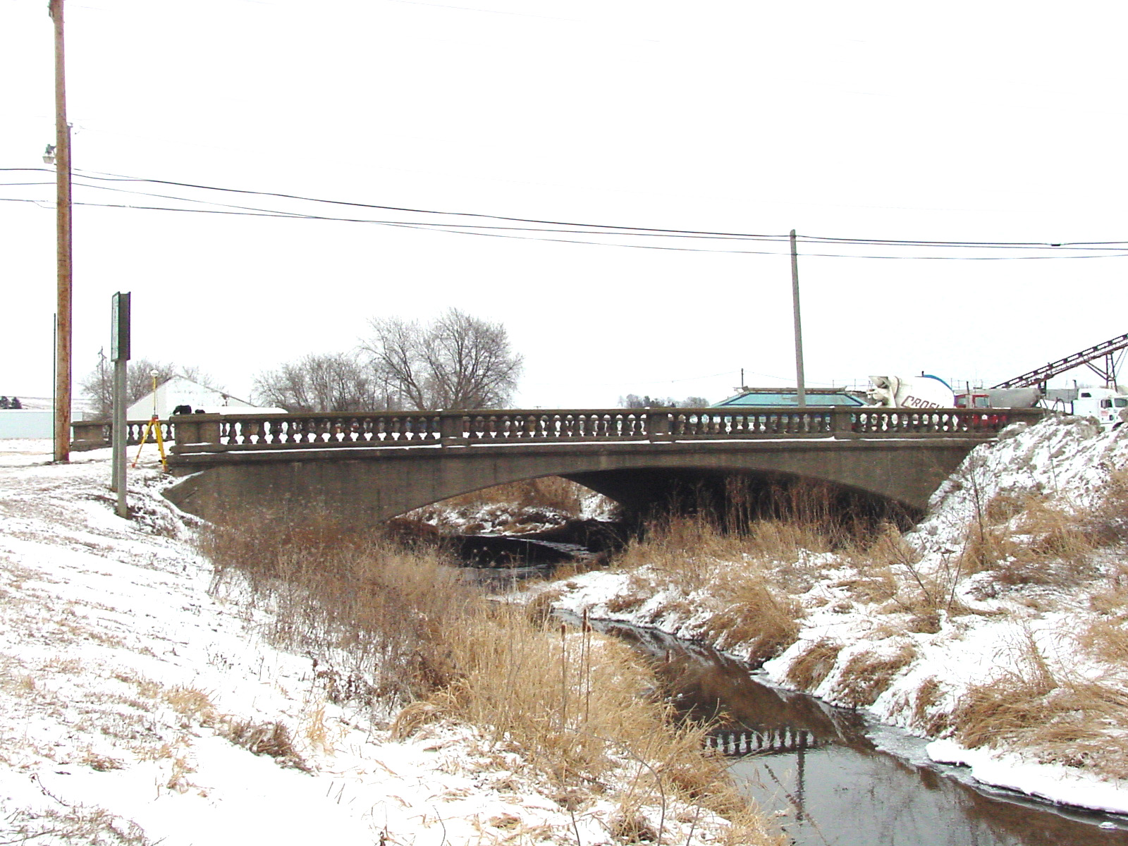 Old historic bridge in the winter over a shallow creek bed